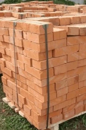 Stack of red bricks on pallets