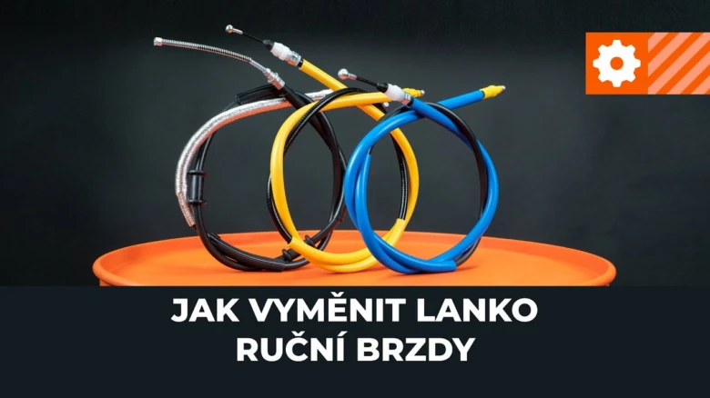 Sada barevných kabelů ruční brzdy na oranžovém podstavci.