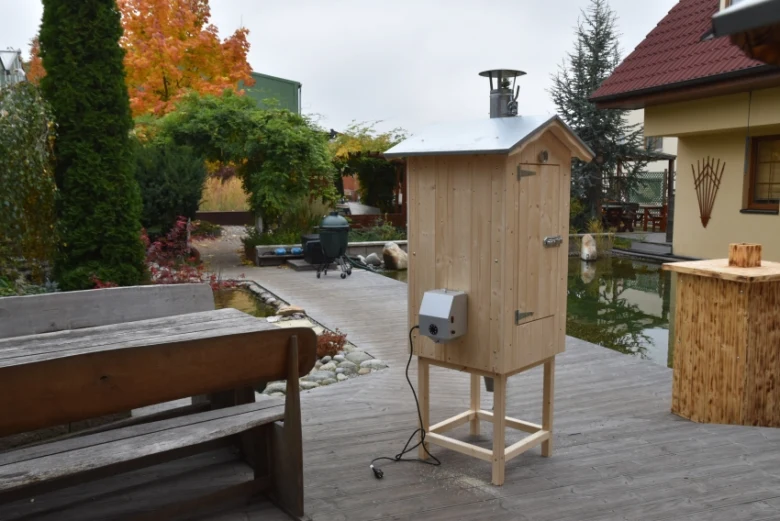 Dřevěný studený kouřák na zahradní terase s elektrickým ovládáním.