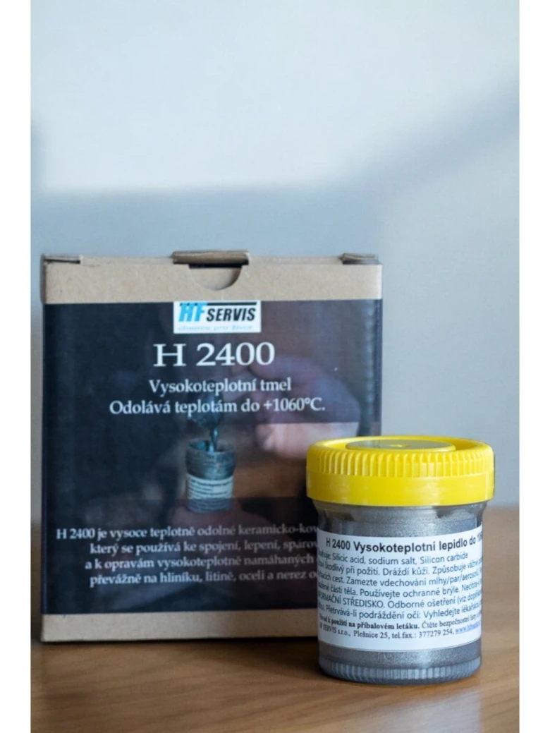 Žlutá nádobka s vysokoteplotním lepidlem vedle krabice HF SERVIS H2400