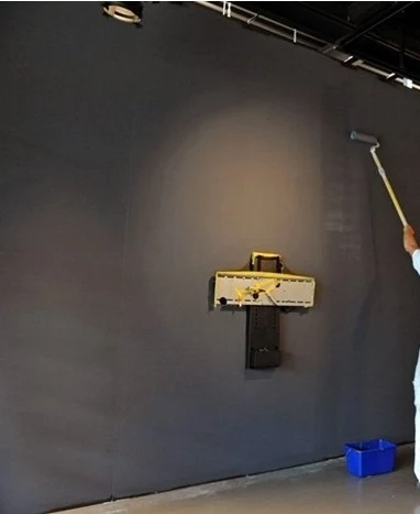 Person painting wall with roller
