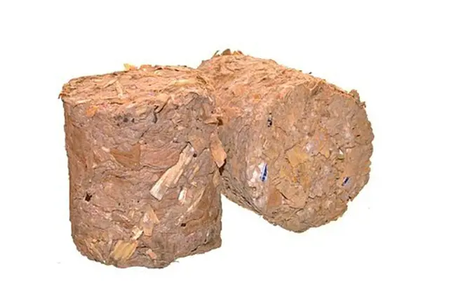 Dva válce briket z pilin jako výsledek výroby.