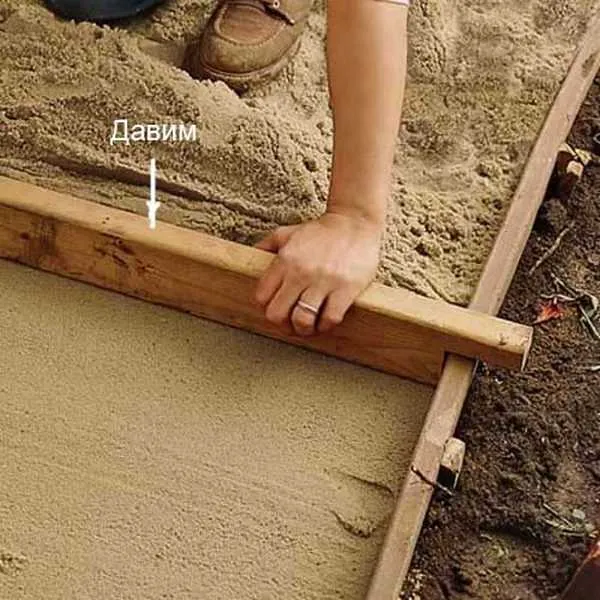 Hand smoothing wet concrete